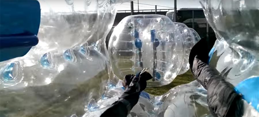 John encased inside a plastic bubble football