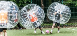 A group playing bubble football on pitch at London Waterloo