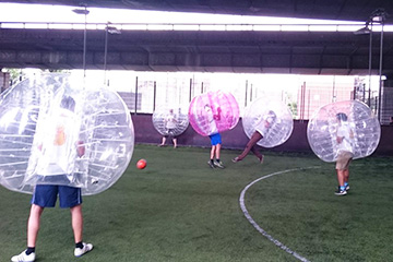 Group playing bubble football in Whitechapel, London